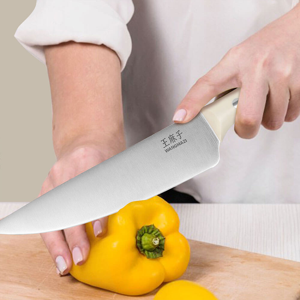 Chef knife of this set is a versatile all-purpose knife with a wide blade and a curved edge, making it ideal for cutting meat, fish, and vegetables. Its unique design makes cutting more efficient, easily handling a variety of ingredients.